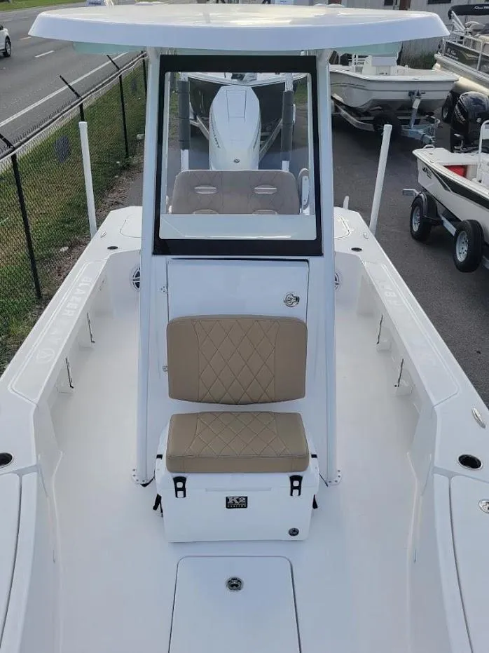 Slide: The Image of 2024 Blazer 2550 GTS center console boat with tan seating and white exterior. - 4