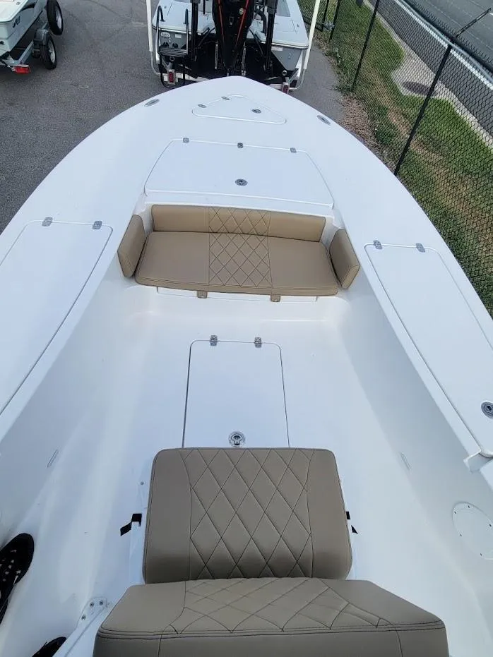 Slide: The Image of 2024 Blazer 2550 GTS boat with tan seating and white deck. - 5