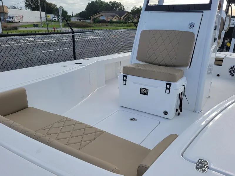 Slide: The Image of 2024 Blazer 2550 GTS boat interior with beige cushioned seating and white deck. - 6