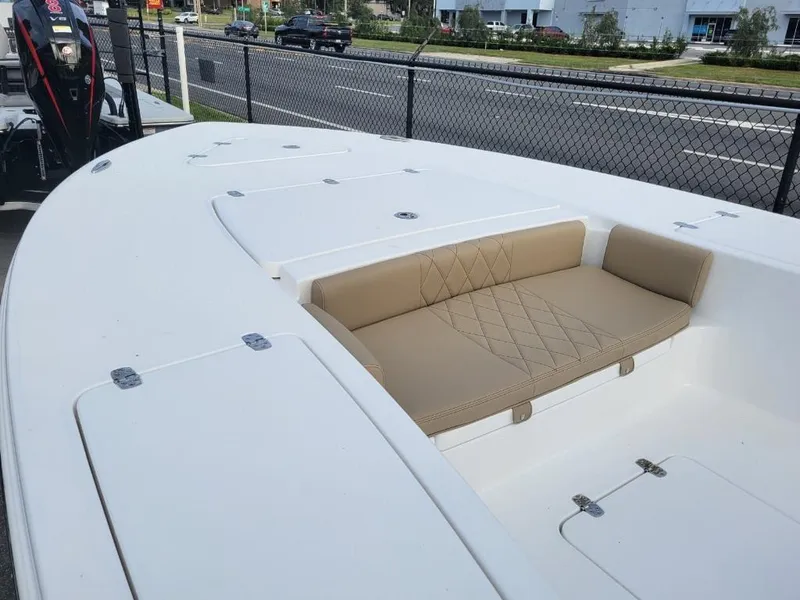 Slide: The Image of 2024 Blazer 2550 GTS boat with tan seating and storage compartments. - 7