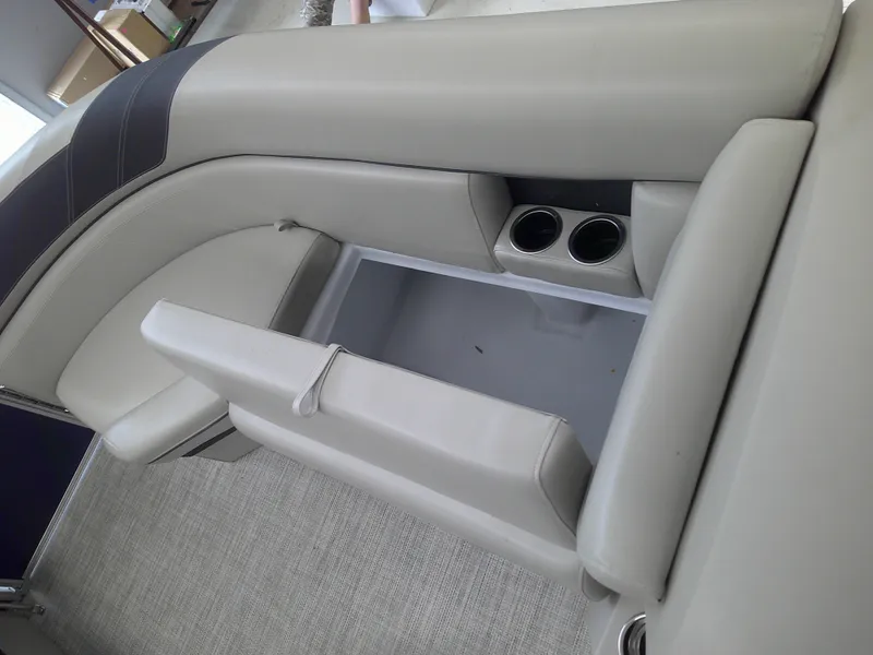 Slide: The Image of 2024 Berkshire 24CL LE 2.75 boat interior with beige seating and cup holders. - 10