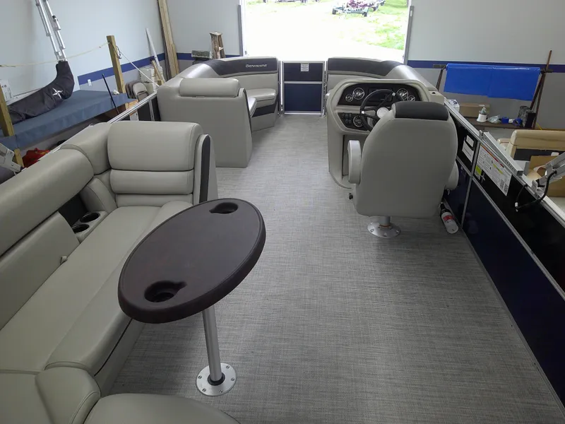 Slide: The Image of 2024 Berkshire 24CL LE 2.75 pontoon boat interior with plush seating and a central table. - 5