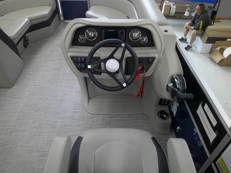 Slide: The Image of 2024 Berkshire 24CL LE 2.75 boat interior, featuring steering console and seating area. - 8