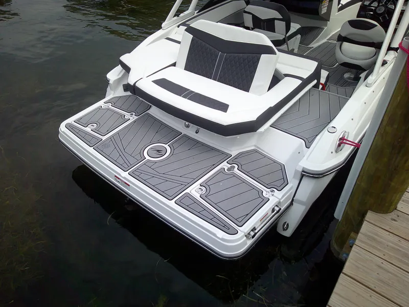 Slide: The Image of 2023 Monterey 218 SS Bowrider boat with a sleek, modern design docked on the water. - 8