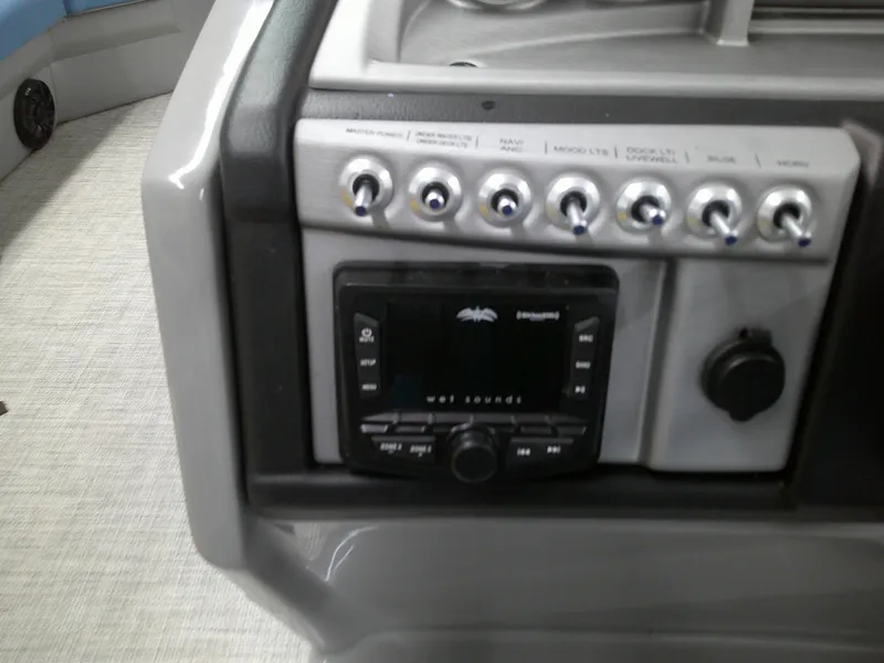 Slide: The Image of Control panel of a 2022 Berkshire 22CL2 CTS boat with audio system and switches. - 10