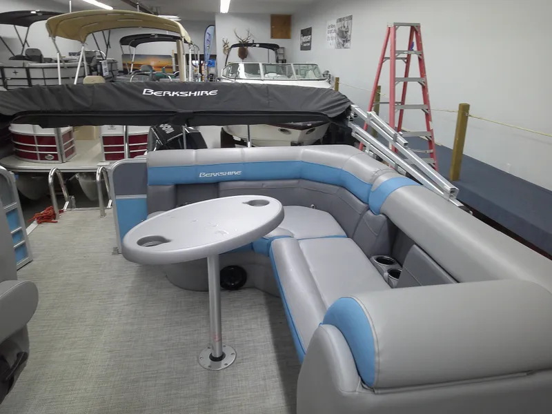 Slide: The Image of 2022 Berkshire 22CL2 CTS pontoon boat interior with gray and blue seating. - 6