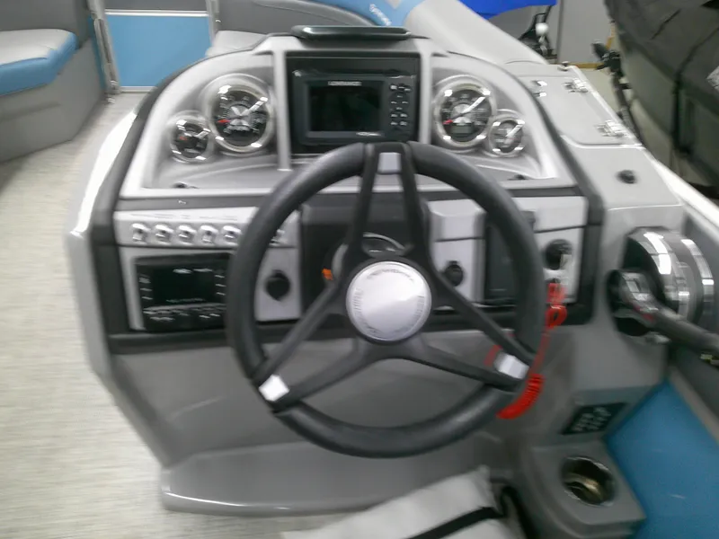 Slide: The Image of 2022 Berkshire 22CL2 CTS boat dashboard with steering wheel and control panel. - 9