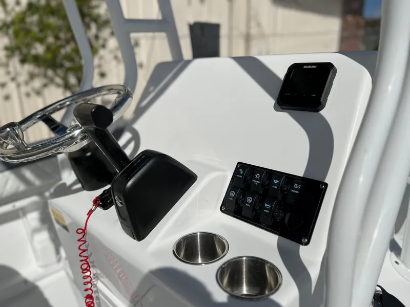 Slide: The Image of Clearwater 2000 boat console, 2024 model, featuring steering wheel, controls, and cup holders. - 10