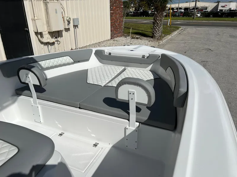 Slide: The Image of 2024 Clearwater 2000 boat interior with gray and white cushioned seating. - 11