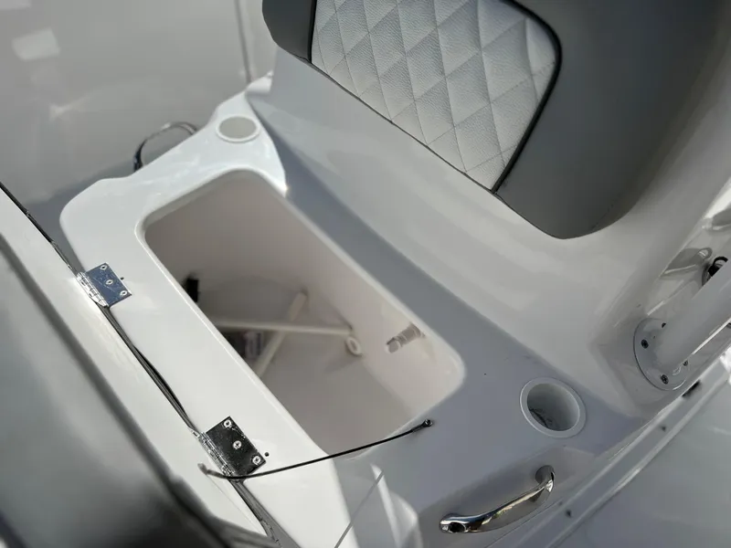 Slide: The Image of Clearwater 2000 boat storage compartment with cushioned seat, 2024 model. - 21