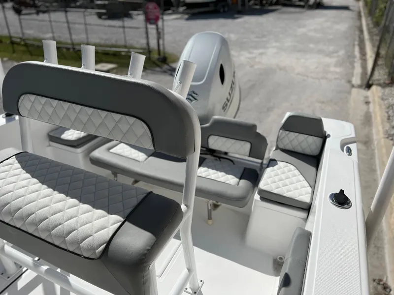Slide: The Image of 2024 Clearwater 2000 boat interior with cushioned seating and Suzuki outboard motor. - 22