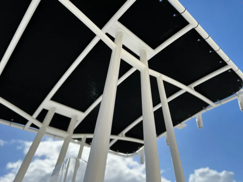 Slide: The Image of Close-up of Clearwater 2000 boat canopy frame against blue sky, 2024 model. - 23