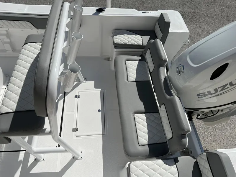 Slide: The Image of 2024 Clearwater 2000 boat interior with Suzuki engine, featuring cushioned seating and rod holders. - 25