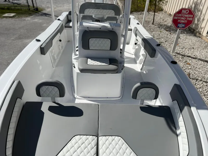 Slide: The Image of 2024 Clearwater 2000 boat interior with gray and white cushioned seating. - 28