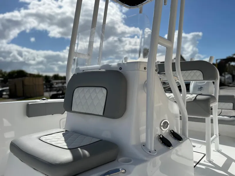 Slide: The Image of 2024 Clearwater 2000 boat interior with cushioned seating and console. - 34