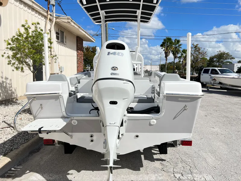 Slide: The Image of Clearwater 2000 boat, 2024 model, rear view with outboard motor, parked outdoors. - 5