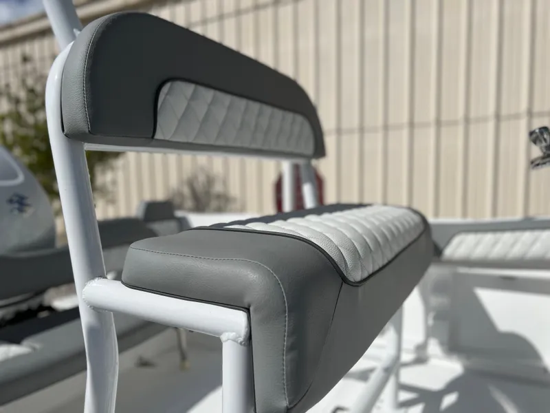 Slide: The Image of Close-up of Clearwater 2000 boat seat, 2024 model, featuring gray and white upholstery. - 9