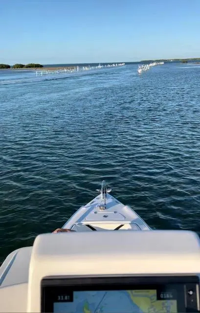 Slide: The Image of 2023 Concept 27 boat navigating calm waters with clear blue sky. - 10
