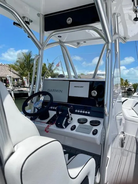 Slide: The Image of 2023 Concept 27 boat cockpit with Garmin and Mercury displays, sleek design, sunny marina backdrop. - 3