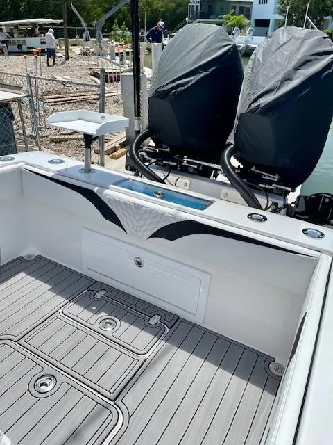 Slide: The Image of 2023 Concept 27 boat interior with dual engines and sleek design at dockside. - 5