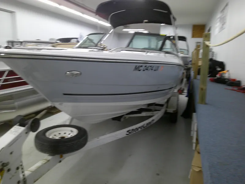Slide: The Image of 2023 Monterey 224 FS Bowrider boat on trailer in indoor storage. - 2