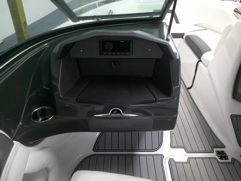 Slide: The Image of 2023 Monterey 224 FS Bowrider interior dashboard and seating area. - 3