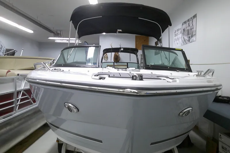 Slide: The Image of 2023 Monterey 224 FS Bowrider boat in showroom, front view with black canopy. - 5
