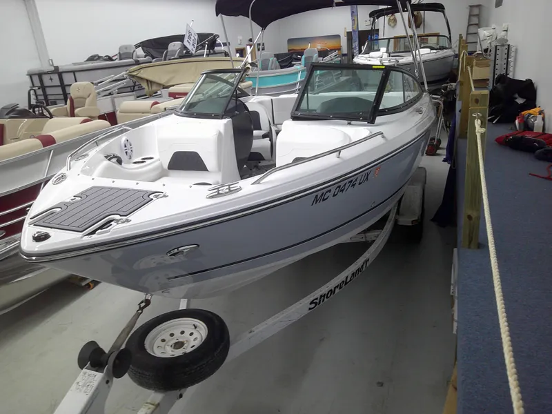Slide: The Image of 2023 Monterey 224 FS Bowrider boat on a ShoreLand'r trailer in a showroom. - 6