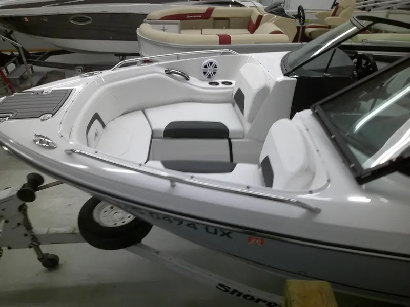Slide: The Image of 2023 Monterey 224 FS Bowrider boat interior with white and gray seating. - 9
