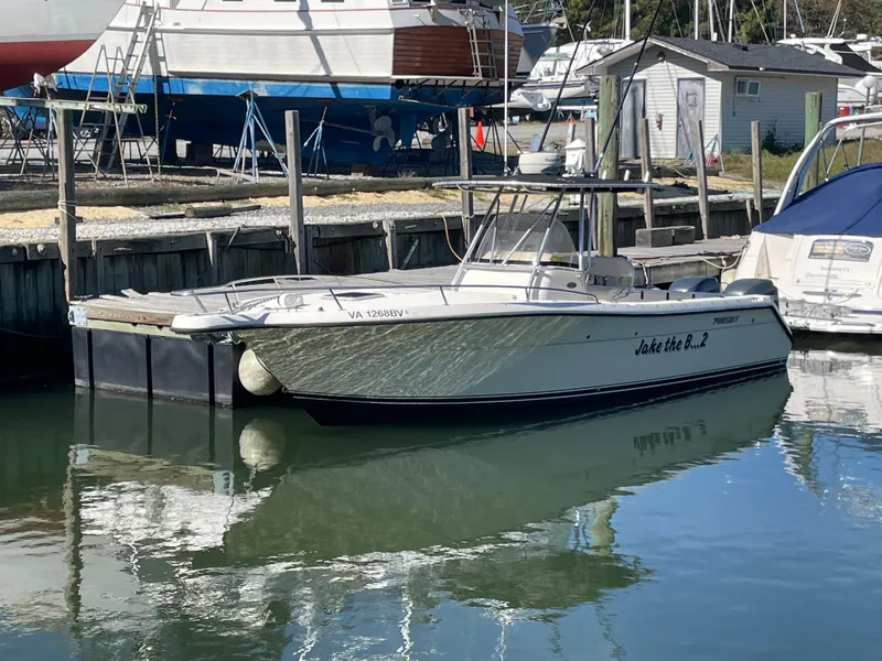 Slide: The Image of 2004 Pursuit 2670 Cuddy Console boat docked in a marina. - 12