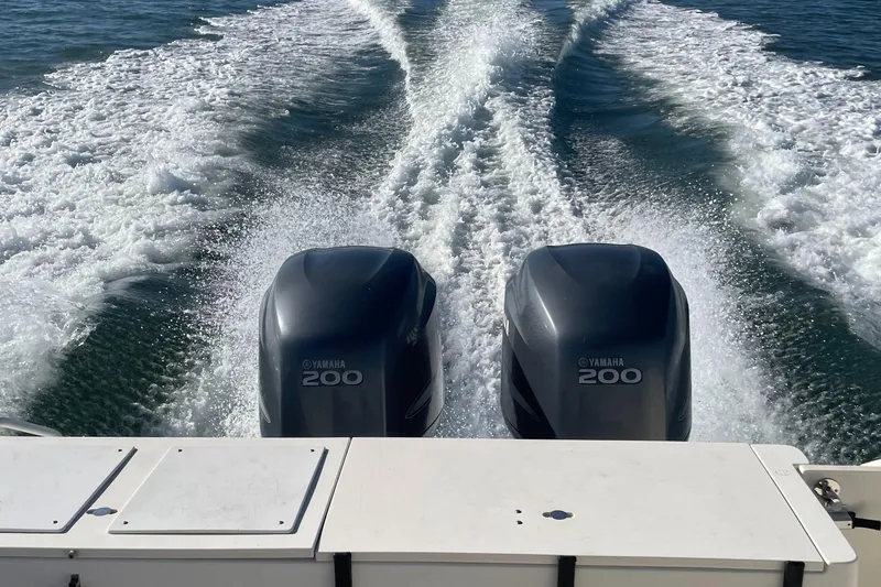 Slide: The Image of 2004 Pursuit 2670 Cuddy Console with twin Yamaha 200 engines on water. - 13