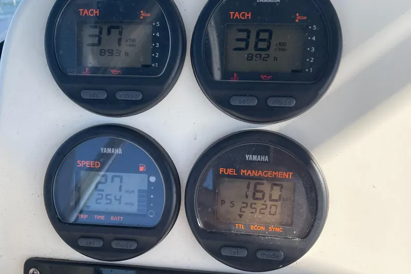 Slide: The Image of Close-up of 2004 Pursuit 2670 Cuddy Console Yamaha gauges displaying tachometer, speed, and fuel management. - 16