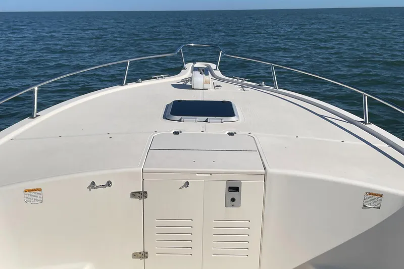 Slide: The Image of 2004 Pursuit 2670 Cuddy Console boat on open water. - 17