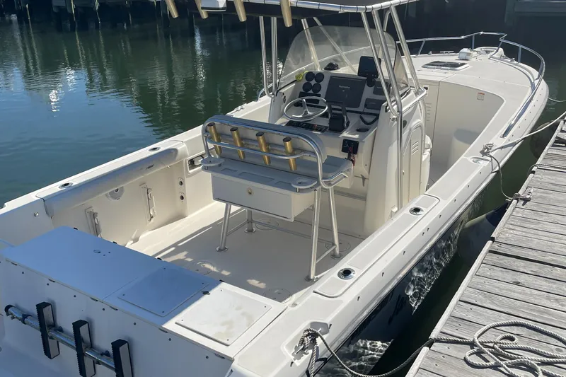 Slide: The Image of 2004 Pursuit 2670 Cuddy Console boat docked at marina. - 21