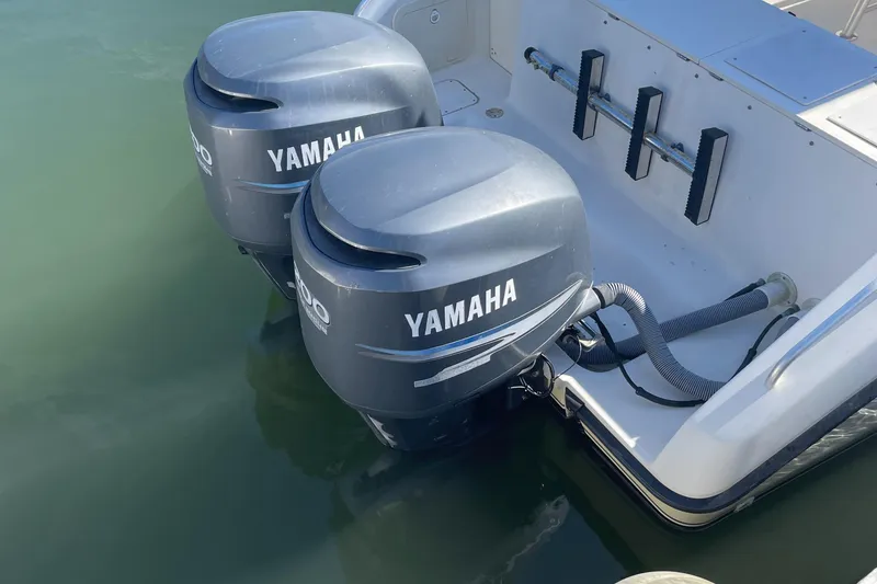 Slide: The Image of 2004 Pursuit 2670 Cuddy Console with twin Yamaha outboard engines. - 22