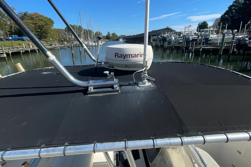 Slide: The Image of 2004 Pursuit 2670 Cuddy Console boat with Raymarine radar at marina. - 23