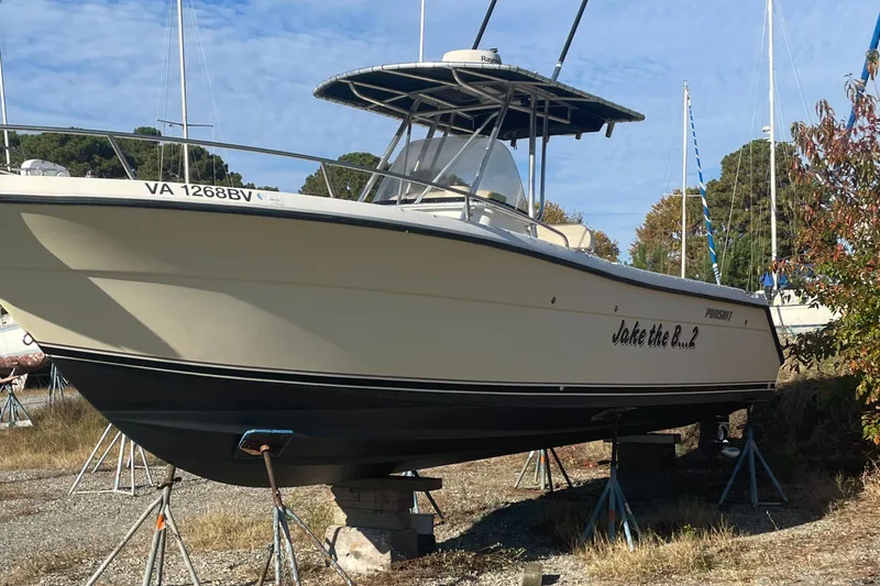 Slide: The Image of 2004 Pursuit 2670 Cuddy Console boat on stands, side view. - 25