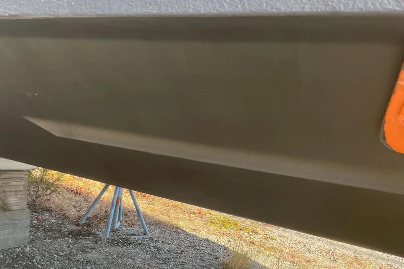 Slide: The Image of Close-up of the hull of a 2004 Pursuit 2670 Cuddy Console boat. - 26