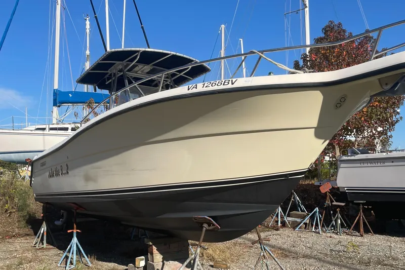 Slide: The Image of 2004 Pursuit 2670 Cuddy Console boat on stands in a boatyard. - 28