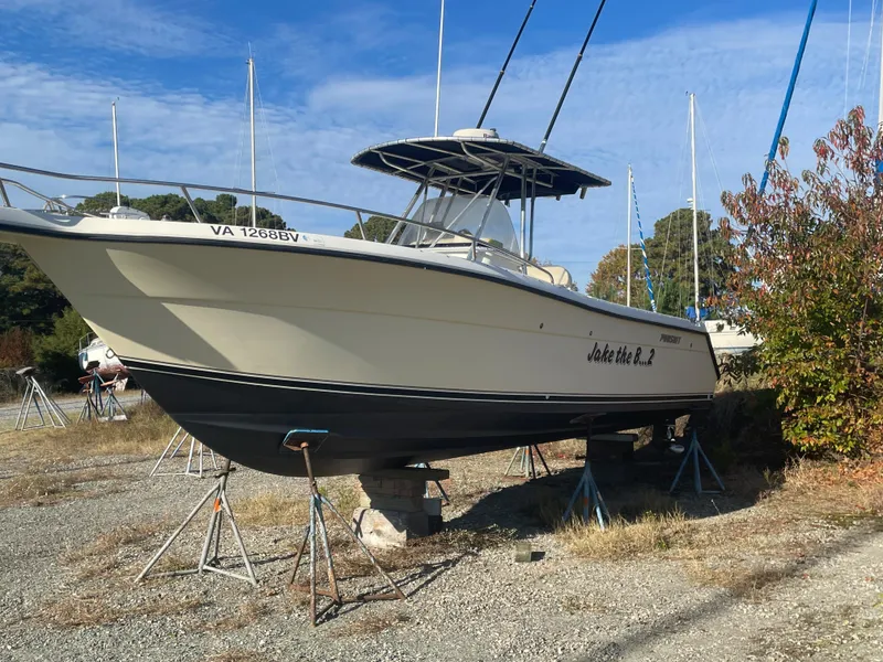Slide: The Image of 2004 Pursuit 2670 Cuddy Console boat on dry dock. - 3