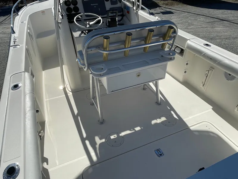 Slide: The Image of 2004 Pursuit 2670 Cuddy Console boat interior with helm and seating. - 31