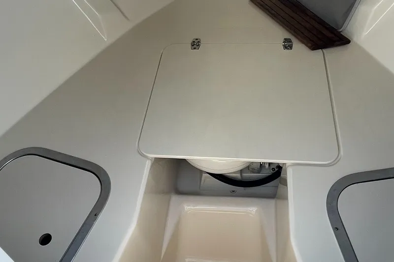 Slide: The Image of 2004 Pursuit 2670 Cuddy Console interior with storage compartments. - 33
