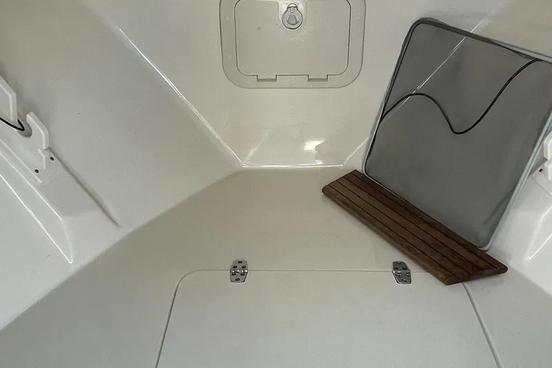 Slide: The Image of 2004 Pursuit 2670 Cuddy Console interior cabin with storage compartments. - 34