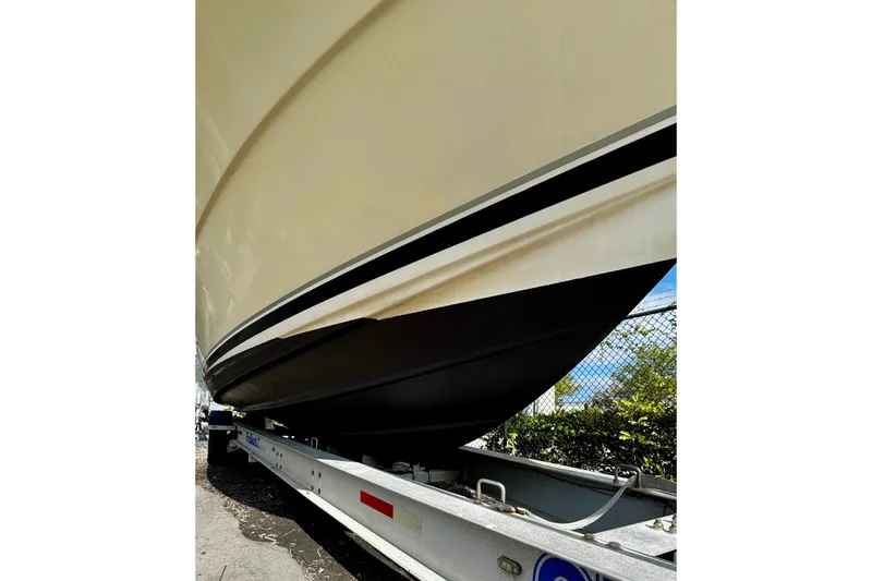 Slide: The Image of 2005 Pursuit 3070 Offshore boat on trailer, close-up view of hull and trailer. - 16