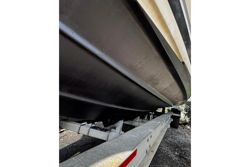Slide: The Image of 2005 Pursuit 3070 Offshore boat hull on trailer, close-up view. - 17