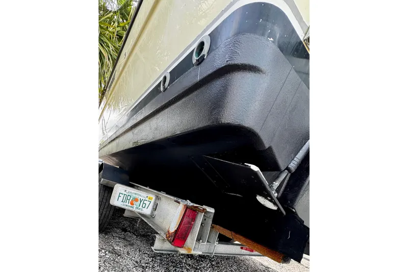 Slide: The Image of 2005 Pursuit 3070 Offshore boat on trailer, rear view with Florida license plate. - 19