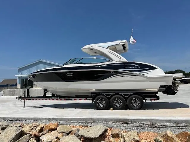 Slide: The Image of 2024 Formula 310 CBR boat on a trailer, parked outdoors. - 1