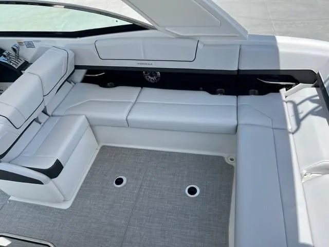 Slide: The Image of 2024 Formula 310 CBR boat interior with white seating and grey flooring. - 16