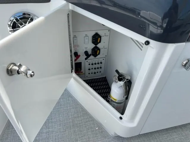 Slide: The Image of Open storage compartment on a 2024 Formula 310 CBR boat with fire extinguisher. - 19