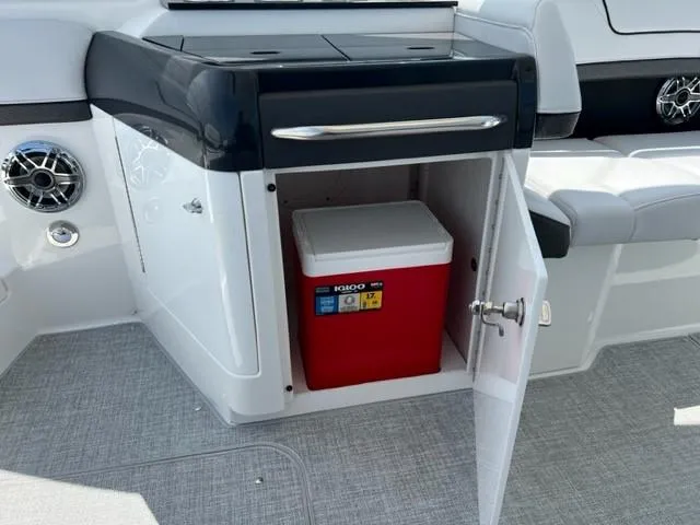Slide: The Image of 2024 Formula 310 CBR boat interior with storage compartment and red Igloo cooler. - 20